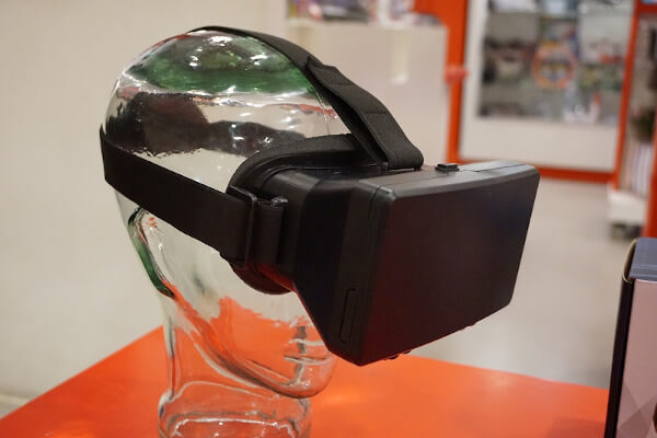 Imagem de uma cabeça de manequim transparente com um óculos de realidade virtual preto.